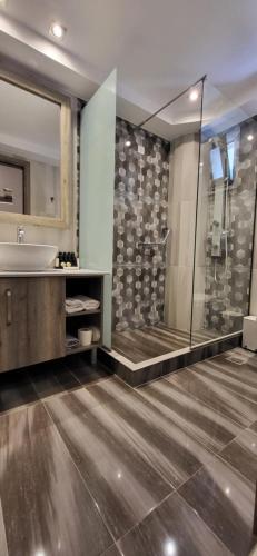 a bathroom with a tub and a sink and a shower at AKRON Luxury Holidays in Ancient Epidavros