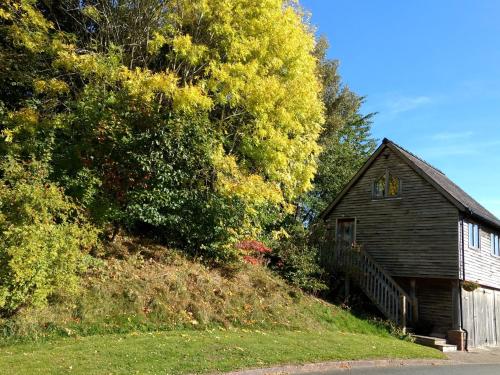 a small house on the side of a hill at The Studio, Upper House Farm, Crickhowell. in Crickhowell