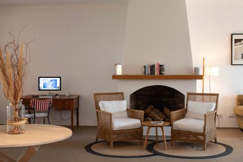 a living room with a table and chairs and a fireplace at Can Jaume by Ocean Drive in Ibiza Town
