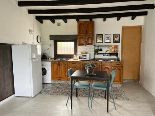 CarrenoにあるCasa Tomasのテーブルと椅子と冷蔵庫のあるキッチン