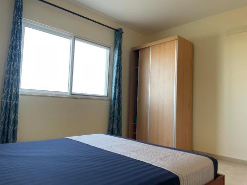 a bedroom with a bed and a large window at Beauty Plaza Suites in Santa Maria