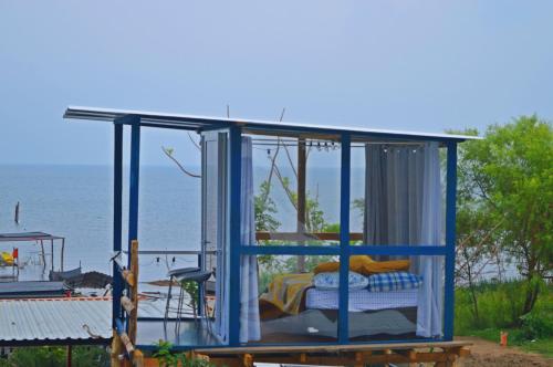 a gazebo with a bed and a window at Mundo Abu San Juan La laguna in San Juan La Laguna