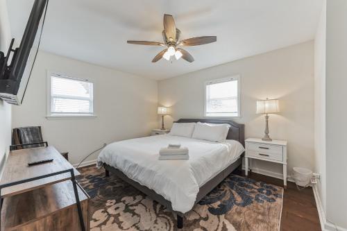 a bedroom with a bed and a ceiling fan at Downtown Hillsborough Duplex in Hillsborough