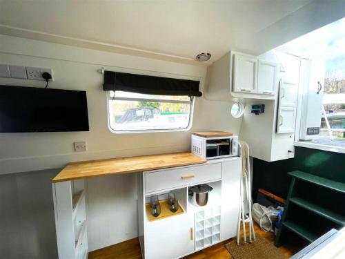 a small kitchen with a counter in a caravan at Executive houseboat in Little Venice in London