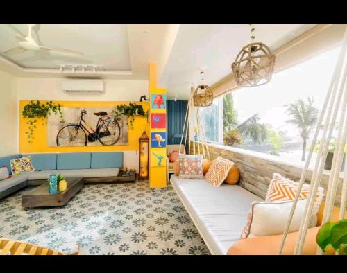 a living room with a couch and a swing at Top-floor Oceanfront Designer Condo In Bandra in Mumbai