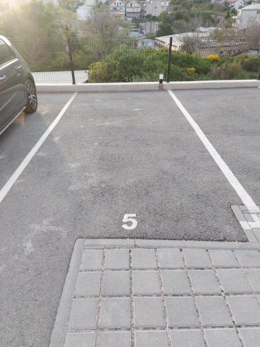 a car parked in a parking lot with the number five at Salona Lux in Klis