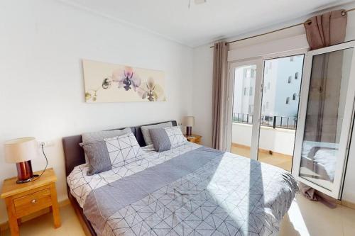 a bedroom with a bed and a large window at Casa-Zeelandia Haciënda Riquelme Sucina Murcia in Sucina