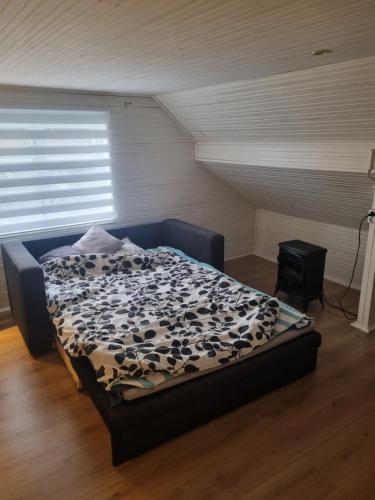 1 dormitorio con 1 cama con edredón blanco y negro en Dom jednorodzinny., en Tomelilla
