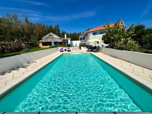 a swimming pool in the backyard of a house at Villa Azul, Graça Portugal in Pedrógão Grande