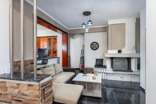 a living room with a couch and a fireplace at Sun & Waves Beachfront Suite in Lampi