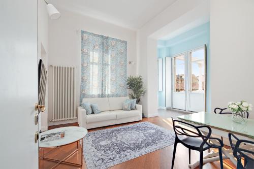 a living room with a white couch and a table at (5 bedrooms) 3 Seasons Villa on Como Lake in Como