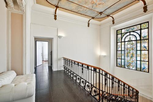 a living room with a couch and a stained glass window at (5 bedrooms) 3 Seasons Villa on Como Lake in Como