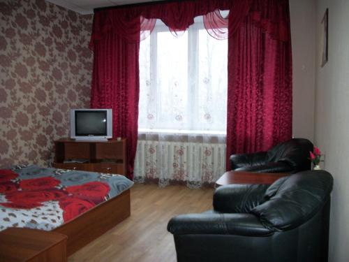 a living room with a couch and a bed and a window at Ariel гостиница in Ivanovo
