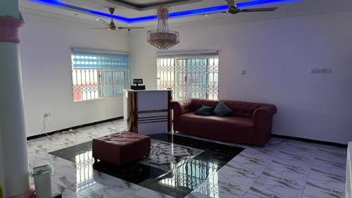 a living room with a couch and a table at KOFFY STAR GUEST HOUSE in Kumasi