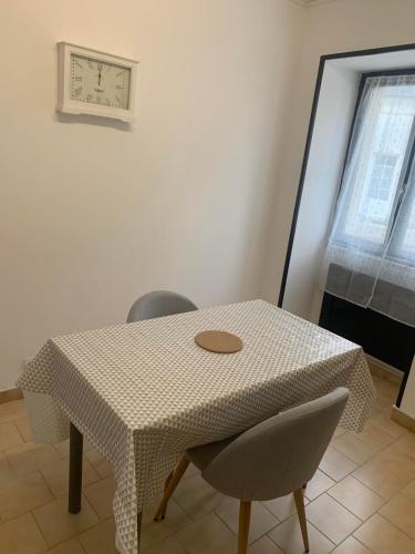 einen Tisch mit 2 Stühlen und einem weißen Tischtuch in der Unterkunft Broc in Broc