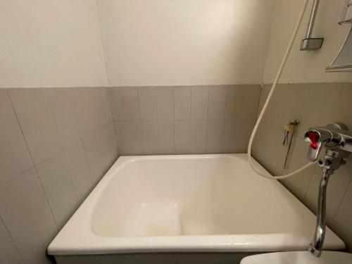 a white bath tub in a bathroom with a sink at Студия in Kouvola