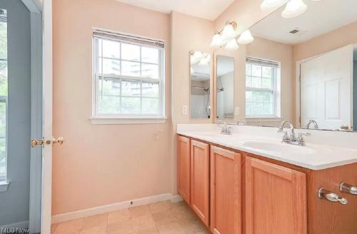 a bathroom with a sink and a mirror at Condo Townhome - Cleveland Lake Area 
