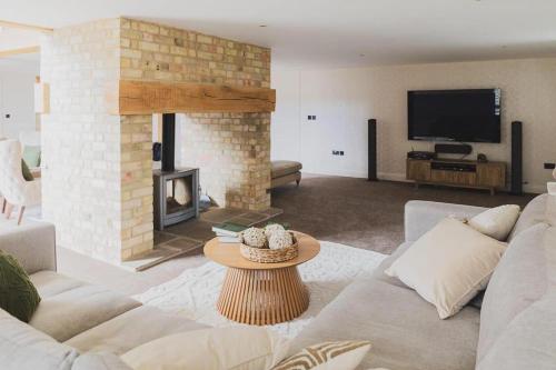 a living room with a couch and a fireplace at Newmarket Gem 5-Bedroom Home with Game Room and Cozy Spaces in Brinkley