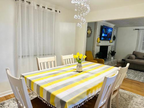a dining room with a table with yellow flowers on it at Sunshine Palace in West Chester