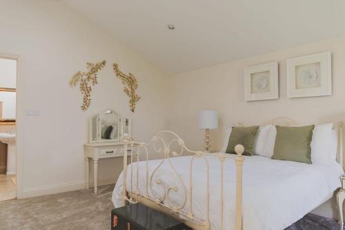 a bedroom with a white bed and a mirror at Newmarket Gem 5-Bedroom Home with Game Room and Cozy Spaces in Brinkley