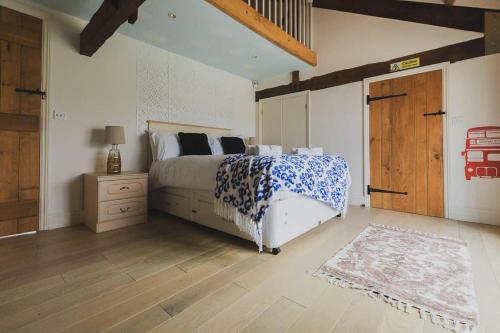 a bedroom with a bed with a blue and white blanket at Newmarket Gem 5-Bedroom Home with Game Room and Cozy Spaces in Brinkley