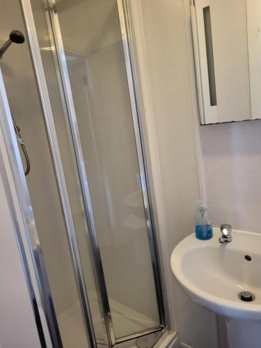 a bathroom with a shower and a sink at Station Guesthouse in Lancaster