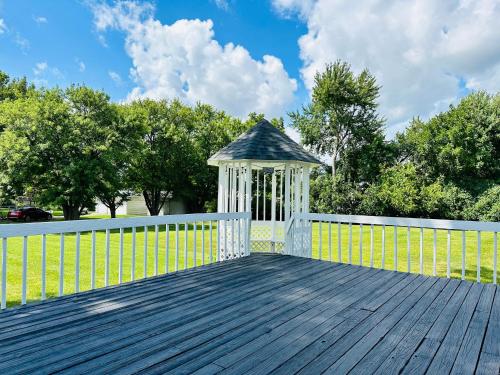 a gazebo on a wooden deck with a fence at Sunshine Palace in West Chester