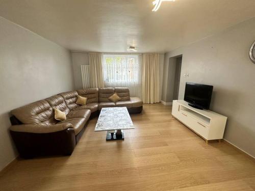 a living room with a couch and a television at Sage House - City centre Hanley, Alton towers in Stoke on Trent