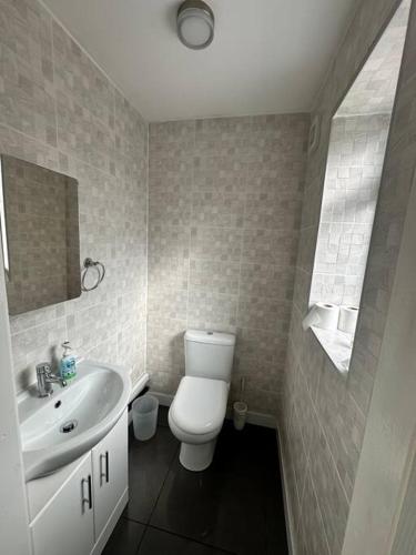 a bathroom with a white toilet and a sink at Sage House - City centre Hanley, Alton towers in Stoke on Trent