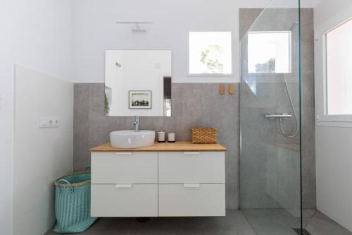 a bathroom with a sink and a shower at CASA LUZ. Casas Los Elementos. in Zahora