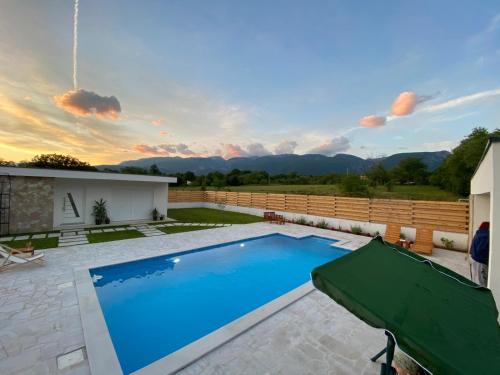 a swimming pool in the backyard of a house at Vestovis Holiday House in Mostar