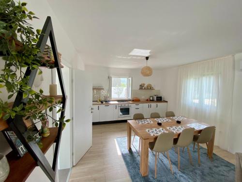 a kitchen and dining room with a table and chairs at Vestovis Holiday House in Mostar