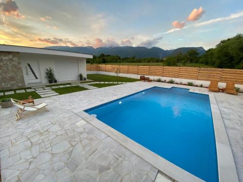 a swimming pool in the middle of a yard at Vestovis Holiday House in Mostar