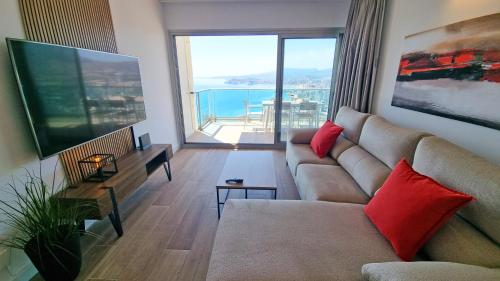 a living room with a couch and a large window at Skyscraper apartment with panoramic views - floor 38 in Benidorm