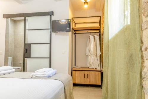 a bedroom with two beds and a closet at Kefalas Luxury Villas Patitiri with Private Pool in Epáno Kefalás