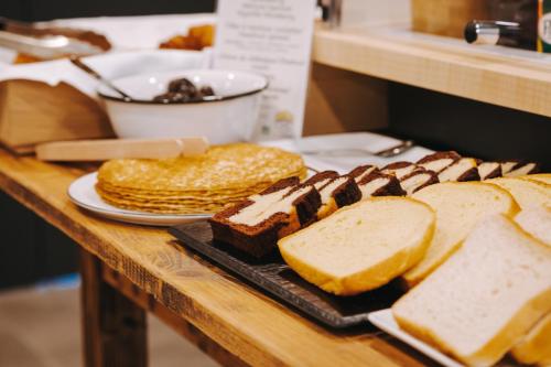 a table with bread and other pastries on it at Beelodge Hotel Blois Centre in Blois