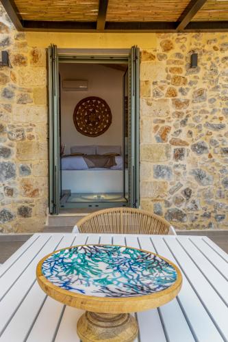 a table sitting on a table in front of a building at Kefalas Luxury Villas Patitiri with Private Pool in Epáno Kefalás