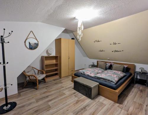 a bedroom with a bed in a attic at Waldblickwohnung für bis zu 5P mit Kamin und Sauna in Sebnitz