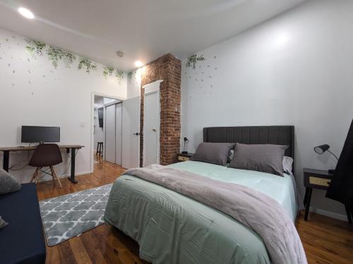 a bedroom with a bed and a table and a desk at Lavish Downtown Manhattan Oasis in Union Square in New York