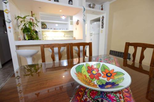 a glass table with a bowl sitting on a chair at El Refugio in Ciudad Lujan de Cuyo