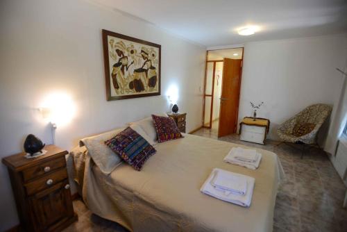 a bedroom with a bed with two towels on it at El Refugio in Ciudad Lujan de Cuyo