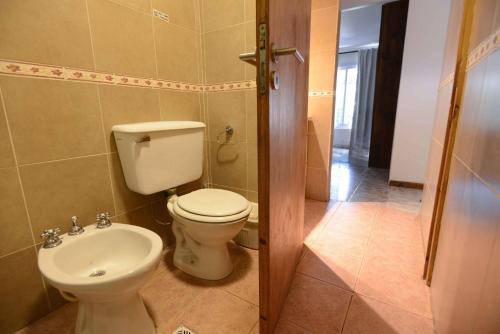 a bathroom with a toilet and a sink at El Refugio in Ciudad Lujan de Cuyo