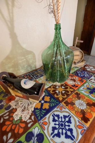 a vase sitting on top of a table with a table cloth at El Refugio in Ciudad Lujan de Cuyo