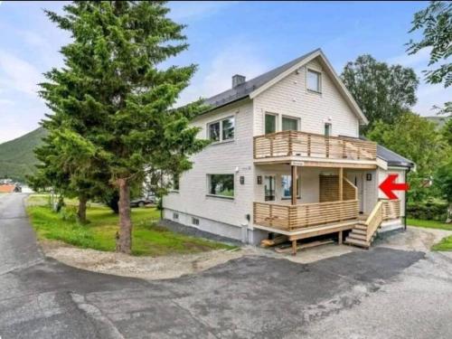 a house with a deck on the side of it at Cozy apartment in Tromsø / Tromsdalen in Tromsø