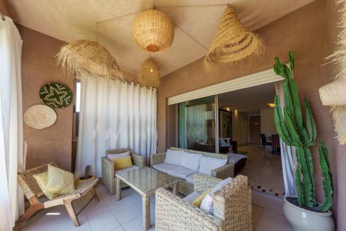 a living room with a couch and a cactus at Stylish Bliss - Dream Apartment in Marrakesh