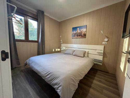 a bedroom with a large white bed in it at Alianza Suites in Madrid
