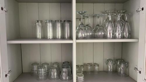 a bunch of glass jars sitting on shelves at Oui-Durbuy in Durbuy