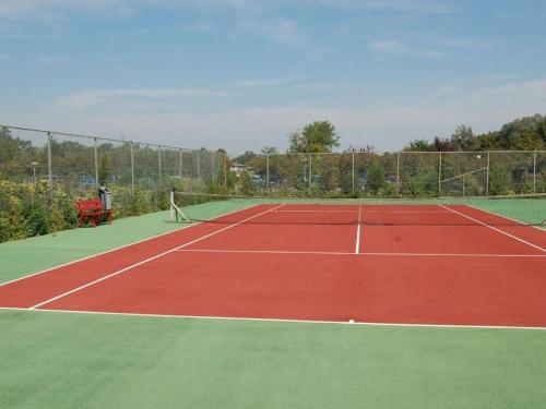 a tennis court with a net on top of it at Beach Bungalow - Noordwijk aan Zee in Noordwijkerhout