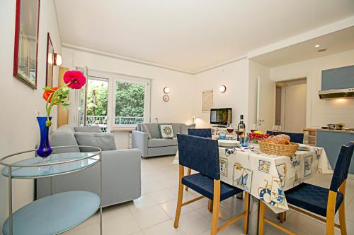 eine Küche und ein Wohnzimmer mit einem Tisch und Stühlen in der Unterkunft Riva Lago e Spiaggia Apartment 3 in Riva del Garda