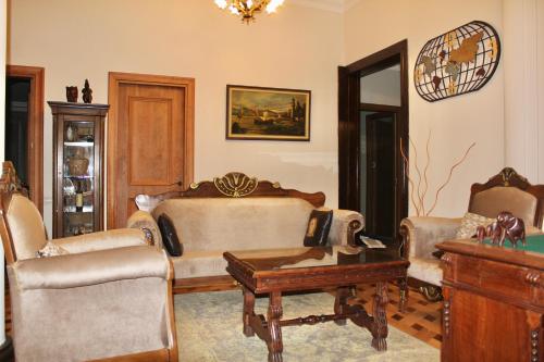 a living room with a couch and chairs and a table at Luxor Garden in Batumi